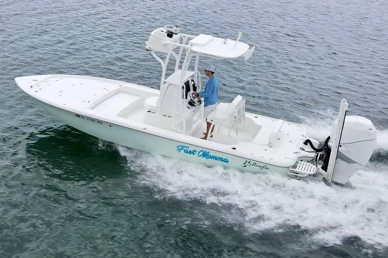 Slide: The Image of 2017 Yellowfin 24 Bay CE boat cruising on water with driver. - 4
