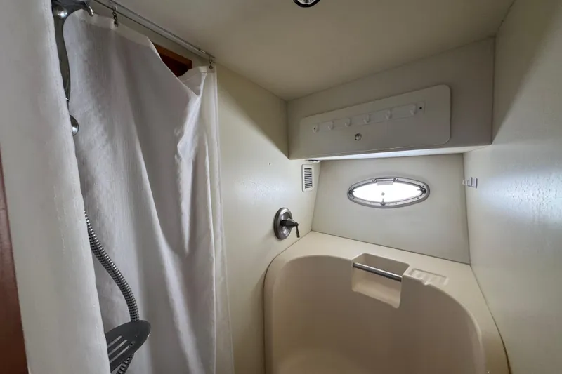 Slide: The Image of Shower area in 2003 Silverton 42 Convertible boat with curtain and porthole window. - 14