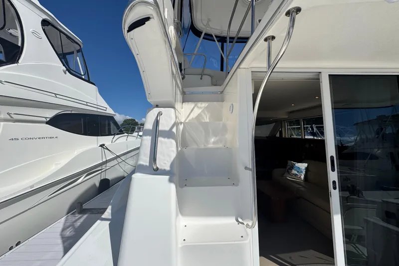 Slide: The Image of 2003 Silverton 42 Convertible yacht with exterior stairs and interior view. - 16