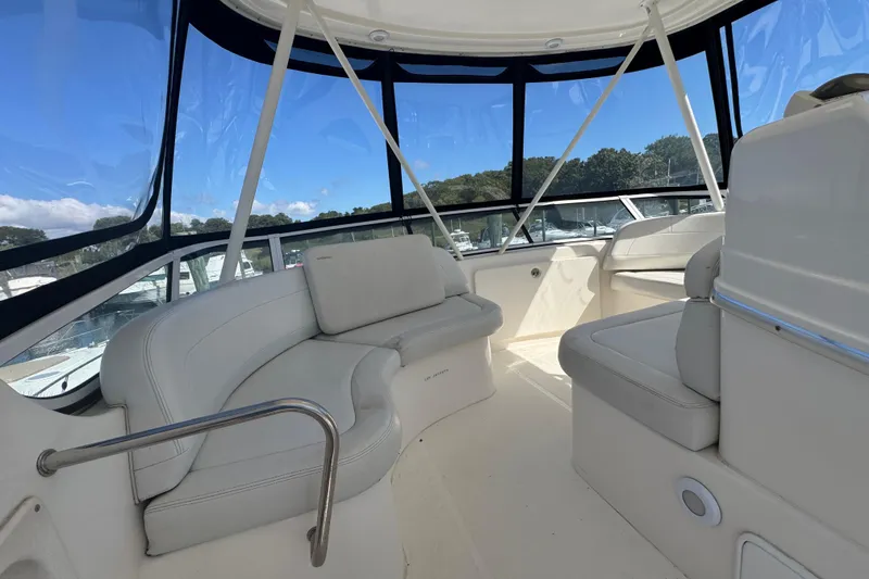 Slide: The Image of 2003 Silverton 42 Convertible yacht interior with white seating and panoramic windows. - 17