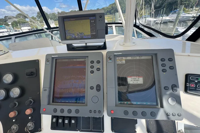 Slide: The Image of Control panel of a 2003 Silverton 42 Convertible yacht with navigation displays. - 21