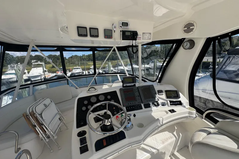 Slide: The Image of Interior view of 2003 Silverton 42 Convertible yacht cockpit with navigation equipment. - 23