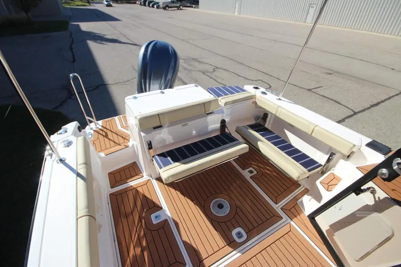 Slide: The Image of 2026 Ranger Tugs R-27 interior storage compartment with open door, showcasing carpeted flooring. - 10