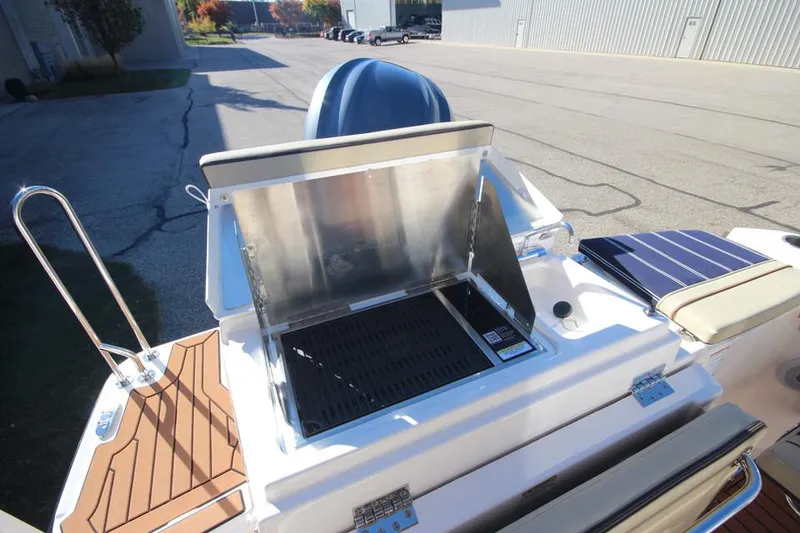 Slide: The Image of 2026 Ranger Tugs R-27 interior with seating, table, and wood accents. - 11