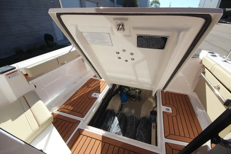 Slide: The Image of 2026 Ranger Tugs R-27 helm with Garmin navigation, wood accents, and modern controls. - 15