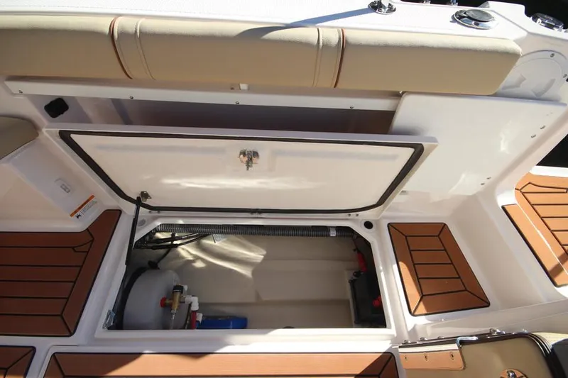 Slide: The Image of 2026 Ranger Tugs R-27 cabin interior with cozy seating and wood accents. - 17