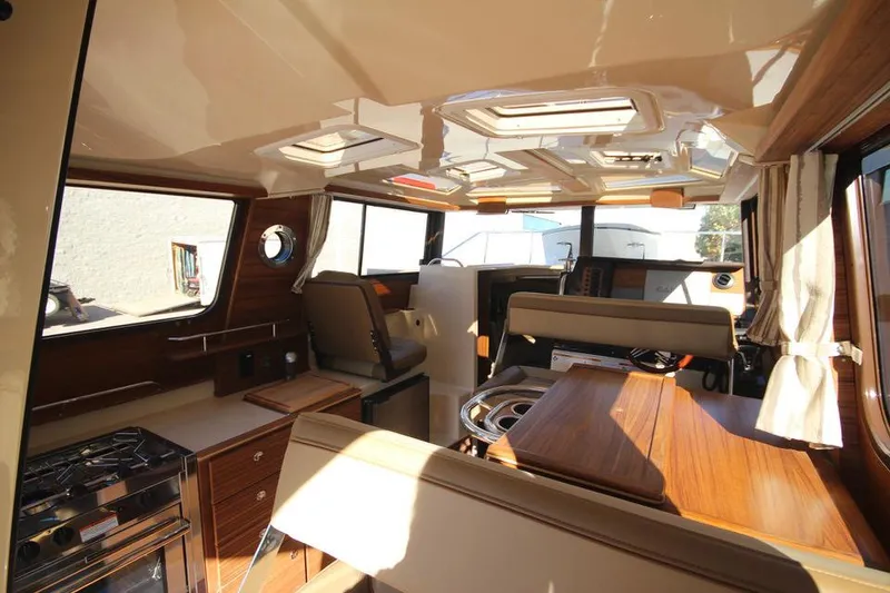 Slide: The Image of 2026 Ranger Tugs R-27 interior with control panel and storage area. - 20