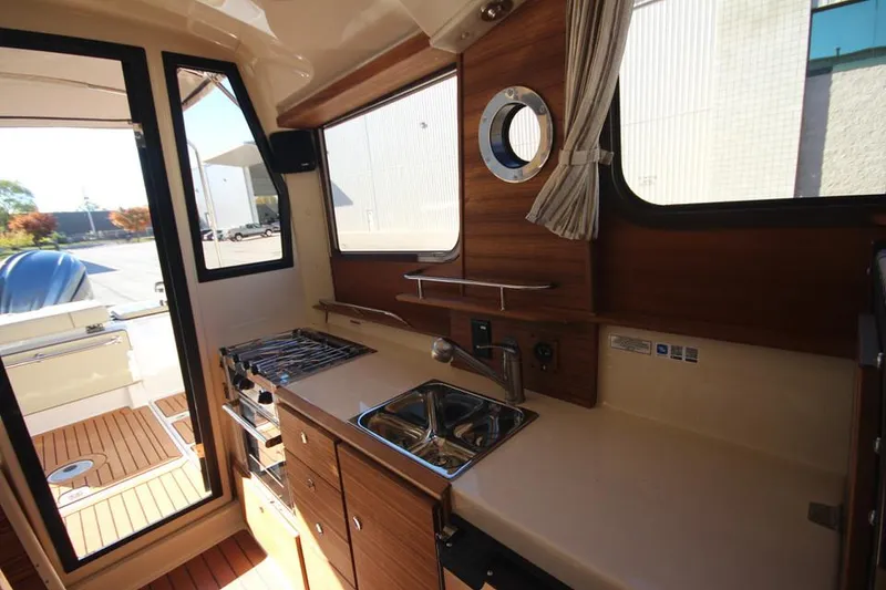 Slide: The Image of 2026 Ranger Tugs R-27 boat interior bathroom with modern sink and toilet. - 21