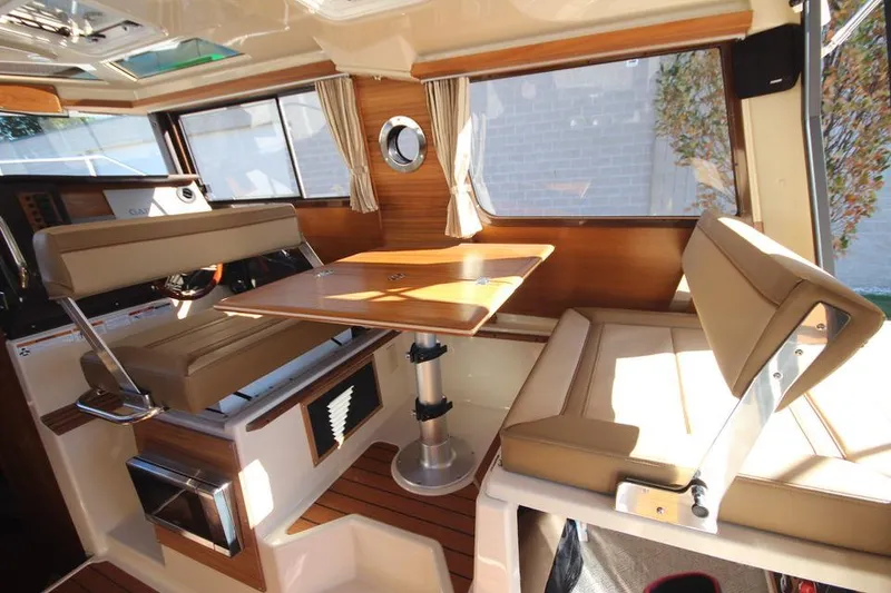 Slide: The Image of 2026 Ranger Tugs R-27 interior with wood paneling and modern lighting. - 22