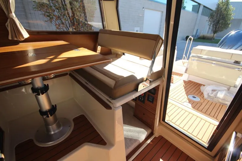 Slide: The Image of Interior of 2026 Ranger Tugs R-27 boat with cozy cabin and modern amenities. - 23