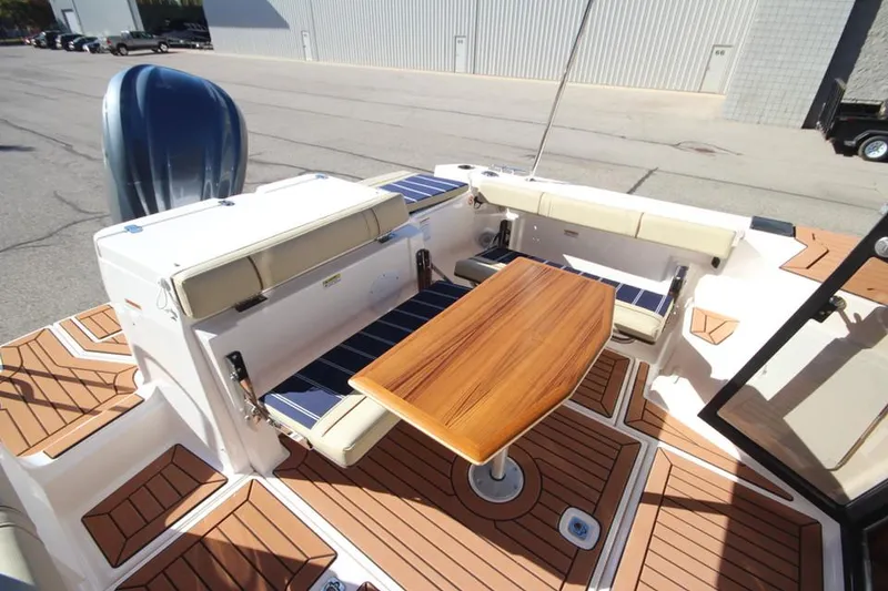 Slide: The Image of 2026 Ranger Tugs R-27 boat deck with open hatch and sleek design. - 28