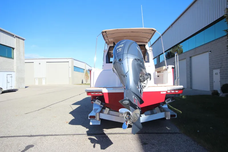 Slide: The Image of 2026 Ranger Tugs R-27 interior view at a boat show, showcasing seating and kitchen area. - 4