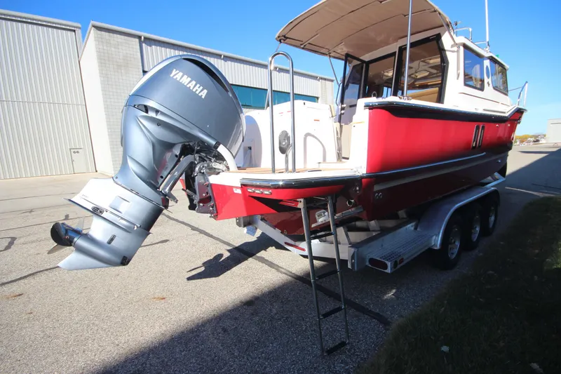 Slide: The Image of 2026 Ranger Tugs R-27 boat interior with foldable seating and dual outboard motors. - 6