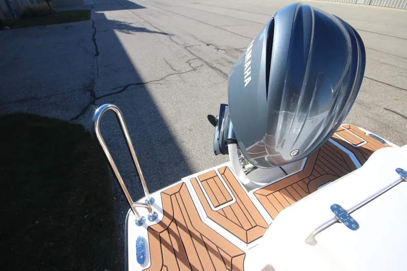 Slide: The Image of 2026 Ranger Tugs R-27 boat storage compartment with wiring and secure latch. - 7