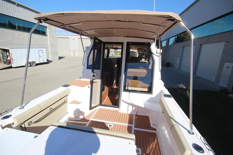 Slide: The Image of 2026 Ranger Tugs R-27 boat compartment with battery and equipment. - 8