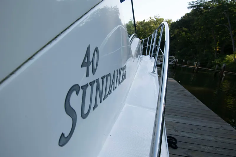 Slide: The Image of 2007 Sea Ray 40 Sundancer yacht docked by a wooden pier. - 10