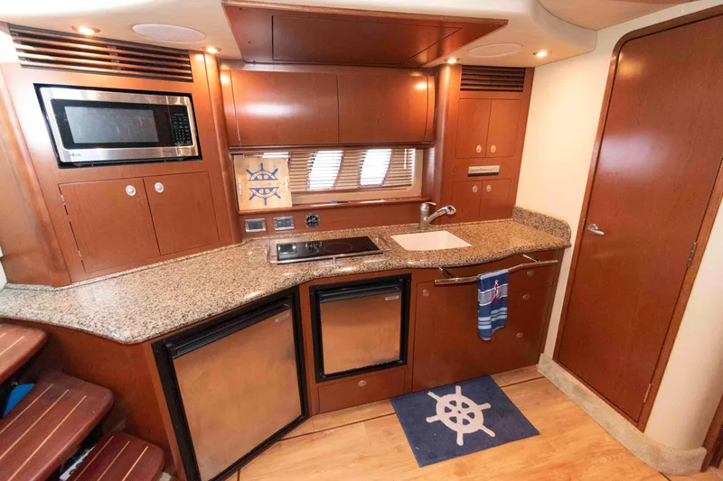 Slide: The Image of Luxurious 2007 Sea Ray 40 Sundancer yacht kitchen with modern amenities and elegant wood cabinetry. - 12