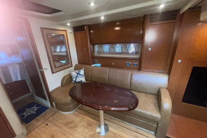 Slide: The Image of Interior of 2007 Sea Ray 40 Sundancer yacht with leather seating and wooden table. - 13