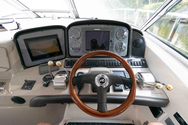 Slide: The Image of Helm of 2007 Sea Ray 40 Sundancer with navigation screens and wooden steering wheel. - 5