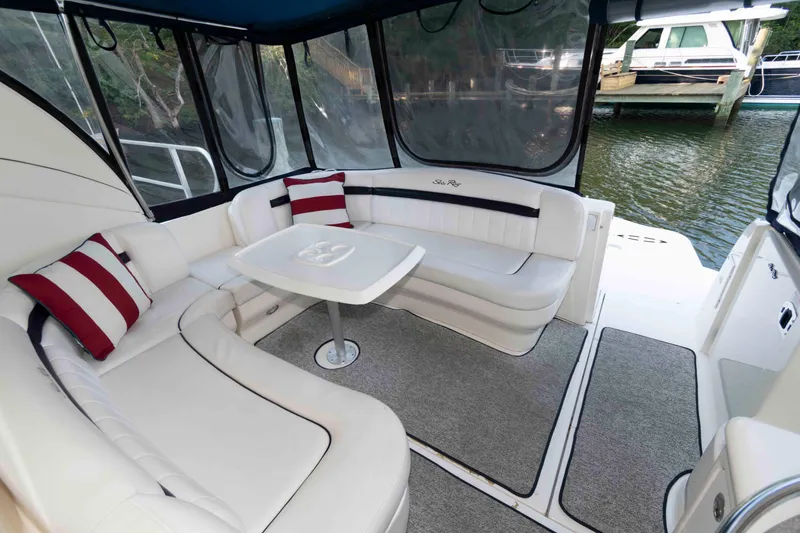 Slide: The Image of 2007 Sea Ray 40 Sundancer yacht interior with white seating and striped cushions. - 7