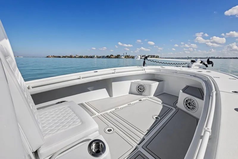 Slide: The Image of 2022 Barker Boatworks 26 Open on calm water, showcasing spacious deck and seating. - 13
