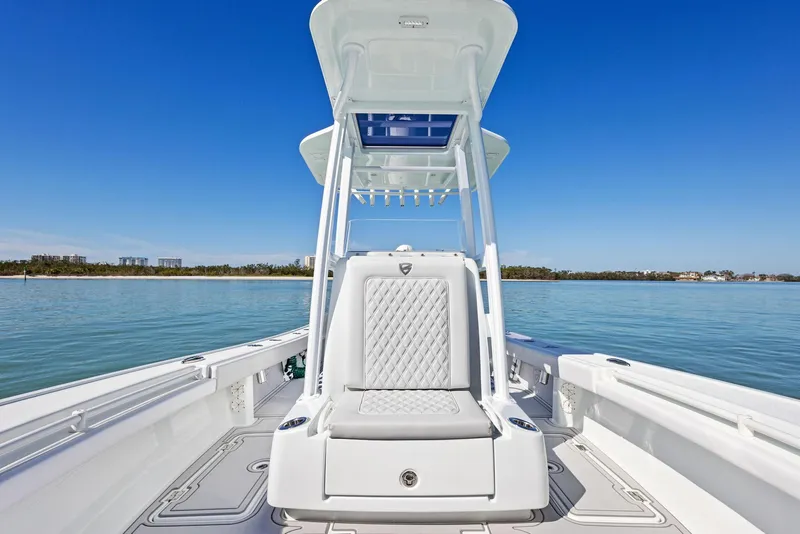 Slide: The Image of 2022 Barker Boatworks 26 Open on calm water, showcasing sleek design and spacious deck. - 14