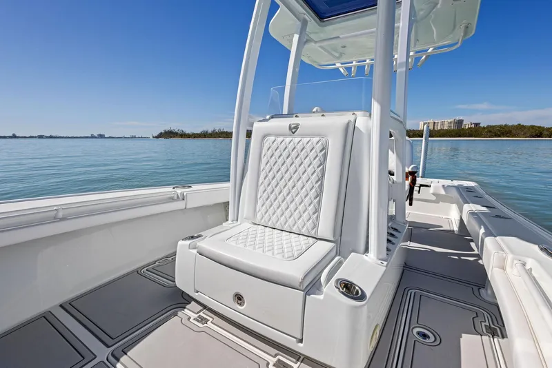 Slide: The Image of 2022 Barker Boatworks 26 Open, luxurious seating, sleek design, calm waters, clear sky. - 15