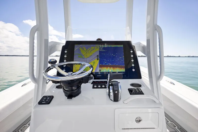 Slide: The Image of 2022 Barker Boatworks 26 Open helm with advanced navigation display on calm waters. - 16