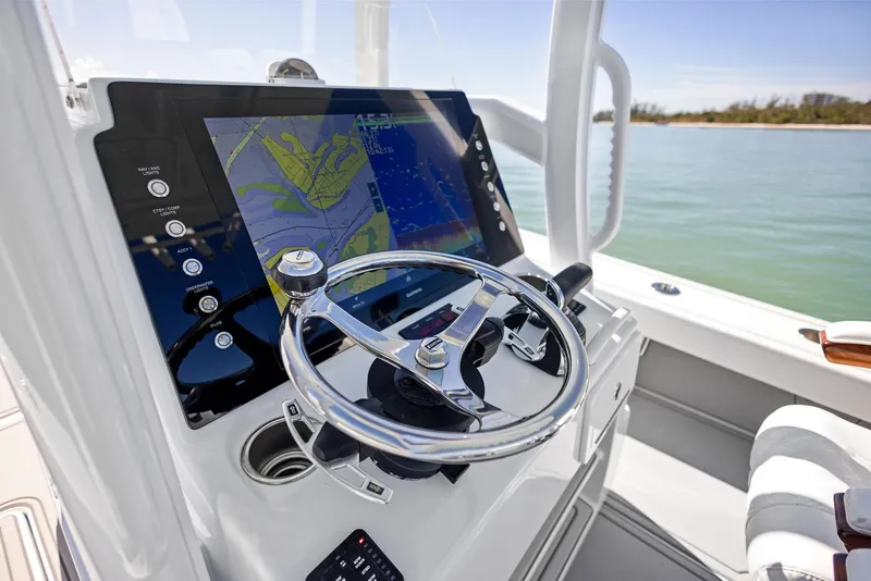 Slide: The Image of 2022 Barker Boatworks 26 Open helm with navigation display on calm water. - 17