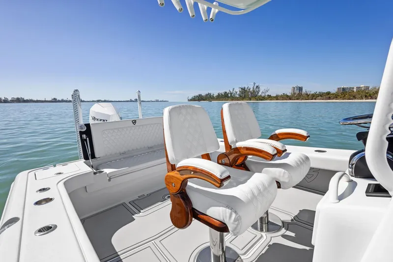 Slide: The Image of 2022 Barker Boatworks 26 Open interior with luxurious seating on calm water. - 18
