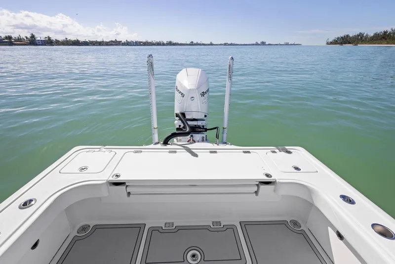 Slide: The Image of 2022 Barker Boatworks 26 Open on calm water, showcasing rear deck and outboard motor. - 24