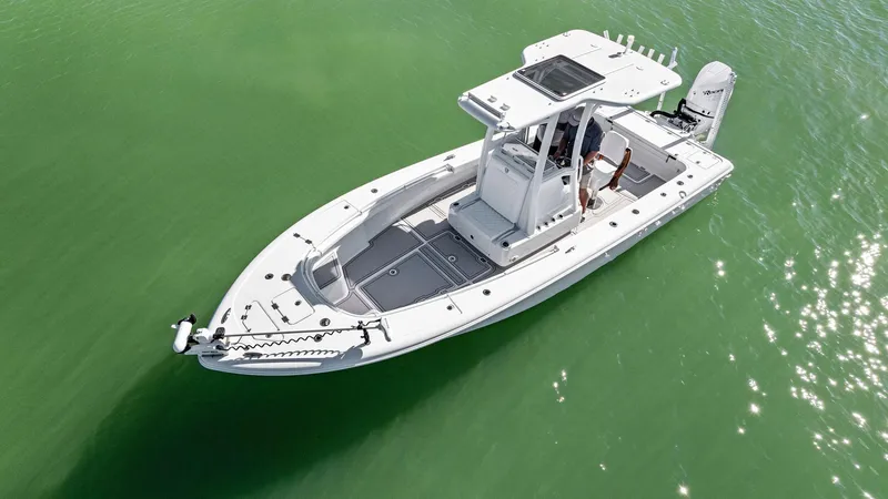 Slide: The Image of 2022 Barker Boatworks 26 Open on calm green water, aerial view. - 4