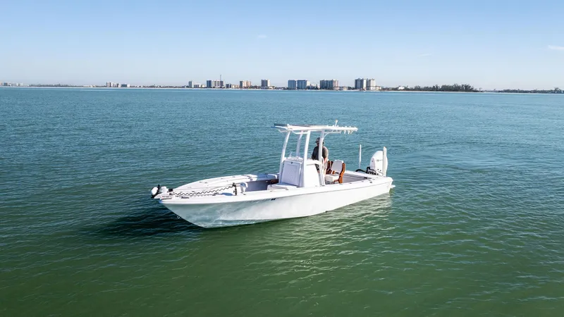 Slide: The Image of 2022 Barker Boatworks 26 Open on calm water with city skyline in background. - 8