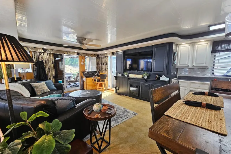 Slide: The Image of Luxurious interior of a 2000 Sumerset 16x75 houseboat with modern decor and cozy seating. - 10