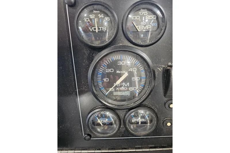 Slide: The Image of Close-up of Sumerset 16x75 2000 boat dashboard gauges, including RPM, volts, and fuel indicators. - 16
