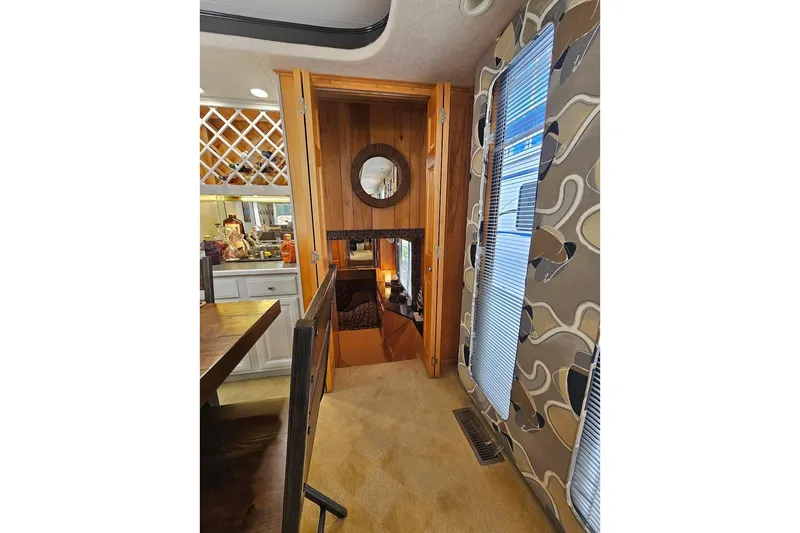 Slide: The Image of Interior of 2000 Sumerset 16x75 houseboat with wooden accents and patterned walls. - 18