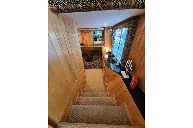 Slide: The Image of Interior of 2000 Sumerset 16x75 houseboat with wooden walls and carpeted stairs. - 19