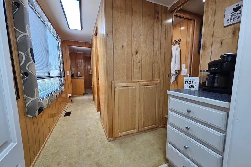 Slide: The Image of Interior of 2000 Sumerset 16x75 houseboat with wood paneling and coffee maker. - 24