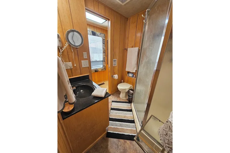 Slide: The Image of Bathroom interior of 2000 Sumerset 16x75 houseboat with shower and vanity. - 31