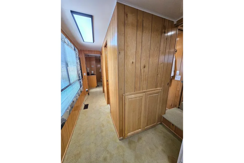 Slide: The Image of Interior hallway of 2000 Sumerset 16x75 houseboat with wood paneling and carpet. - 33