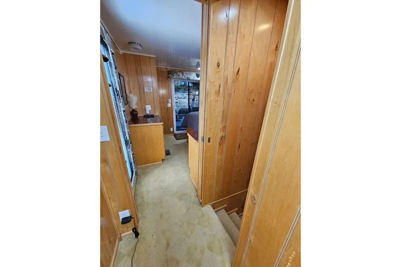 Slide: The Image of Interior hallway of 2000 Sumerset 16x75 houseboat with wood paneling and carpet. - 40