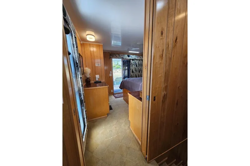 Slide: The Image of Interior of 2000 Sumerset 16x75 houseboat with wood paneling and cozy bedroom. - 41