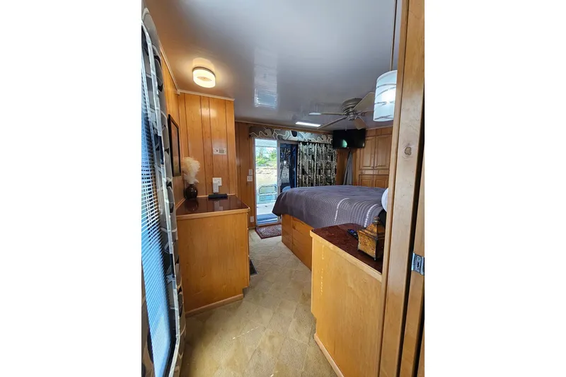 Slide: The Image of Cozy bedroom interior of 2000 Sumerset 16x75 houseboat with wood paneling and modern decor. - 43