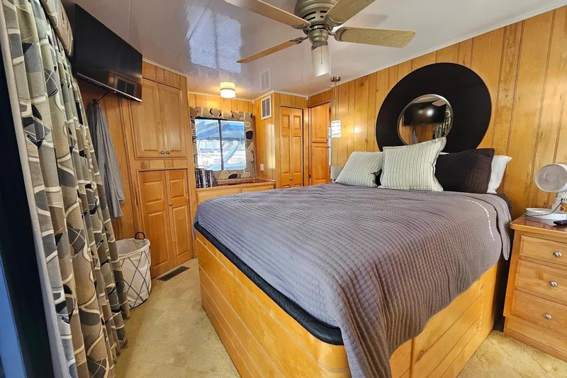Slide: The Image of Cozy bedroom in 2000 Sumerset 16x75 houseboat with wood paneling and modern decor. - 44