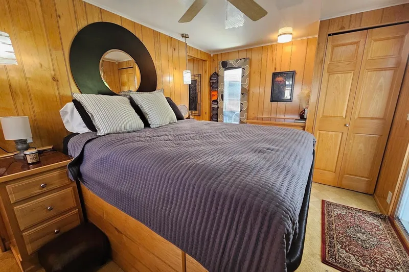 Slide: The Image of Cozy bedroom in 2000 Sumerset 16x75 houseboat with wood paneling and modern decor. - 45