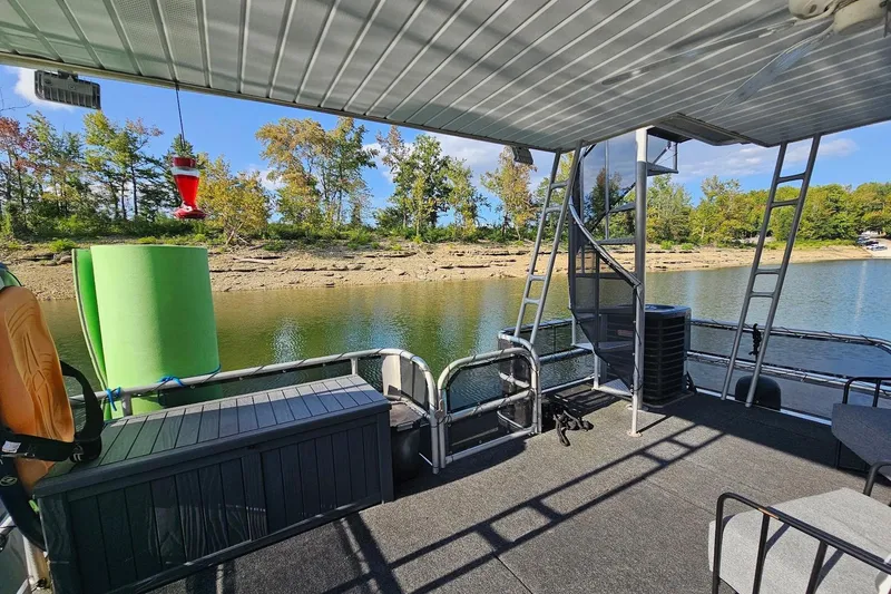 Slide: The Image of Houseboat deck view on a 2000 Sumerset 16x75, overlooking a serene lake and trees. - 52