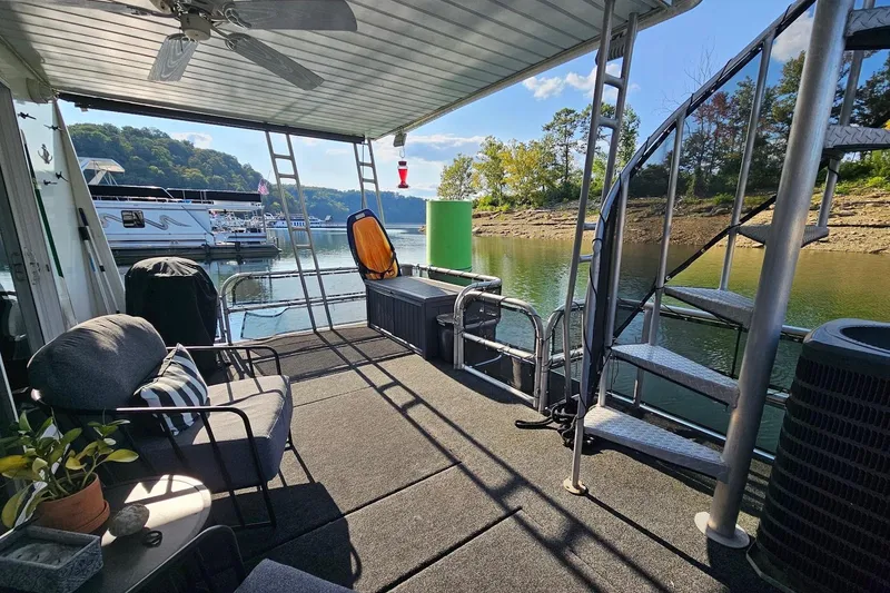Slide: The Image of Houseboat deck with seating, spiral staircase, and scenic lake view. Sumerset 16x75, year 2000. - 53