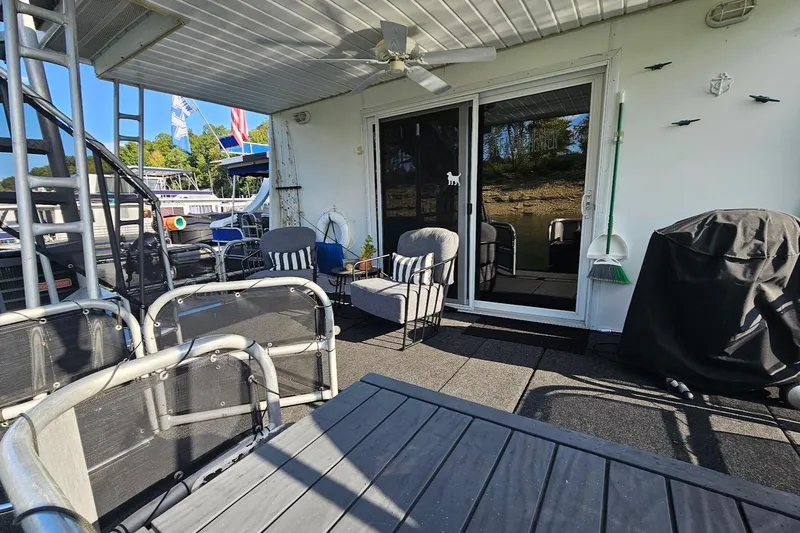 Slide: The Image of Outdoor seating area on 2000 Sumerset 16x75 houseboat with chairs and grill. - 55