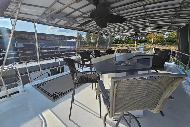 Slide: The Image of Upper deck of 2000 Sumerset 16x75 houseboat with seating and bar area. - 57