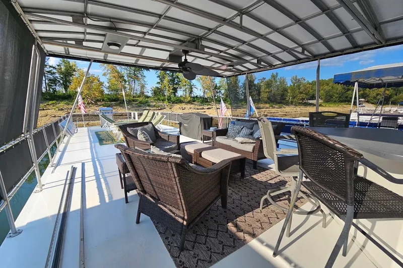 Slide: The Image of Spacious outdoor deck on 2000 Sumerset 16x75 houseboat with wicker furniture and scenic views. - 60